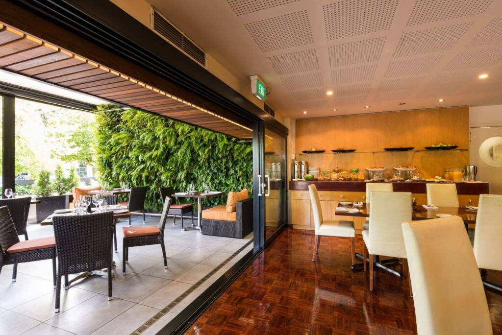 Scenic garden view from The George Christchurch during high tea service.