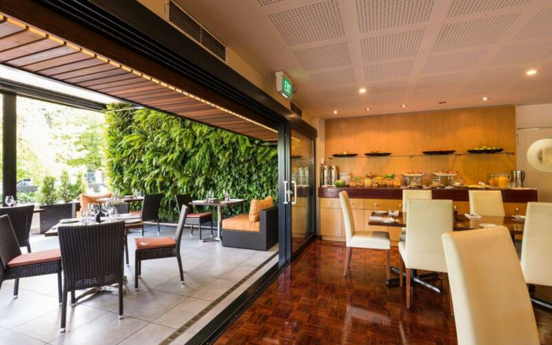 Scenic garden view from The George Christchurch during high tea service.